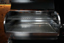 Interior view of a pellet grill featuring a Pimp My Grill® Gen2 Slide-Out Rack System - 1 Rack installed above the primary cooking grate.