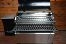 Two metal slide-out rack system levels from the Pimp My Grill® Gen2 Slide-Out Rack System - 2 Racks extend outward from the open lid of a Recteq Patio Legend 410 pellet grill.