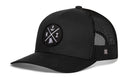 The Haka Hat Rhode Island Trucker Hat | Black RI X Snapback features a classic black mesh back and a black and white front patch with an anchor, “RI,” and the outline of Rhode Island.