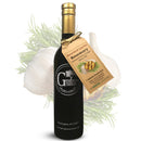 A dark bottle of Georgetown Olive Oil Co. ROASTED GARLIC ROSEMARY Infused High Polyphenols Extra Virgin Olive Oil with a tan tag, displayed in front of garlic bulbs and rosemary sprigs. The label highlights the superior flavor and quality provided by its high polyphenol extra virgin olive oil.