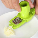 A person uses the Lovely Home Icon 1PCS Garlic Crusher Press Multi-Functional Manual Ginger Garlic Grinding Grater Cutter Garlic Peeler to shred a small piece of food, possibly garlic or ginger, onto a white plate.