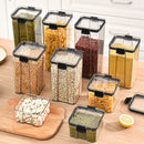 Eight Lovely Home Icon 1-4PCS Sealed Jars Kitchen Organizer Grain Storage Boxes, featuring clear bodies with black lids, hold a variety of dry foods such as pasta, beans, millet, and nuts. These large-capacity, reusable seasoning jars are neatly arranged on a kitchen counter next to a sliced lemon and one separated lid.