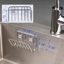 The Lovely Home Icon Sponge Holder For Kitchen Sink is a stainless steel suction cup sponge caddy, wall-mounted on the sink. It doubles as an organizer for sponges or soap and features blue measurement lines showing its size: 4.15 inches wide, with sections measuring 2.28 and 2.36 inches, and a height of 2 inches, highlighted in a close-up inset for clarity.
