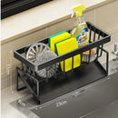The Lovely Home Icon Sponge Draining Rack – Dishcloth & Dishwashing Liquid Storage Kitchen Organizer is a black plastic caddy designed to hold a dish brush, yellow sponges, dish soap, steel wool, and a scrubber. Crafted from waterproof materials for repeated use, it measures 23 cm in length, 9 cm in width, and 11 cm in height. This organizer sits conveniently on your countertop near the sink.