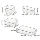 Ten clear plastic organizers from the Lovely Home Icon 10-Piece Versatile Drawer Organizer Set, featuring trays and dividers in four different sizes, each labeled with dimensions in inches and centimeters. Arranged neatly on a white background, this set is ideal for makeup or kitchen storage, allowing you to keep your space tidy while easily viewing your items.