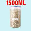 A clear jar from Lovely Home Icon, labeled as the Plastic Sealed Tank Large Capacity Crisper Kitchen Organize Grain Storage Box with Scale, securely holds small brown pellets. Above this airtight spice container, “1500ML” is displayed in large red letters against a light blue background, highlighting its suitability as an ideal kitchen organizer.