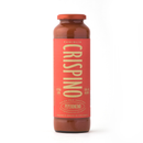 A tall glass bottle of Taycte Famiglia Crispino Calabrian Chili Pasta Sauce Starter — Peperoncino with a red label, gold text, Italian branding, and a brown cap stands against a plain white background.