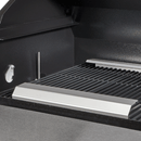 Close-up of a clean, empty metal grill with shiny cooking grates and heat plates inside a black barbecue grill. The grill lid is open, revealing the grilling surface—perfect for high heat grilling or upgrading your setup with the Smokin Brothers HeatWave searing accessory from Smokin Brothers.