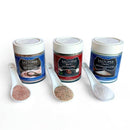 The SALTOPIA Infused Sea Salts SALT SNOBS Gift Set features three jars of gourmet sea salt—Pink Himalayan, Salt Pepper Garlic, and Mediterranean Flake—each with a ceramic spoon for sampling. A perfect gift set for sea salt lovers.