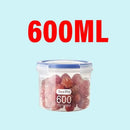 A clear Plastic Sealed Tank Large Capacity Crisper Kitchen Organize Grain Storage Box with Scale from Lovely Home Icon, labeled “600ML,” is filled with vibrant red, round items—possibly fruit—and securely closed with a blue-sealed airtight lid for optimal freshness. The transparent spice container sits against a light blue background, with “600ML” prominently displayed in bold red text above it—making it a stylish and practical addition to any kitchen for organized grain or spice storage.