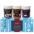 The SALTOPIA Infused Sea Salts SALT SNOBS Gift Set features Pink Himalayan, Salt Pepper Garlic, and Mediterranean Flake salts displayed on a blue box with utensil illustrations.