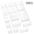 Thirteen clear plastic storage boxes from the Lovely Home Icon 10-Piece Versatile Drawer Organizer Set, featuring trays and dividers in four sizes for makeup and kitchen storage, are arranged on a white background. The text “13PCS” appears in the top right corner.