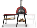 A red and black outdoor pizza oven on wheels with a wood storage shelf below, featuring a WPPO LLC Direct Infinity Side Table Long Side (103cm) with a slatted lower shelf attached on the left side, providing extra space for meal prep and serving. The side table fits Infinity 50 and 66 models.