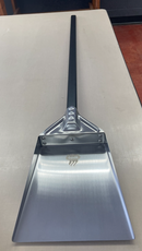 The WPPO Ash Shovel with Black Alumina Handle by WPPO LLC Direct, featuring a wide, flat silver blade, rests on a light-colored table—perfect for effortlessly moving ashes or pizzas in and out of the oven.