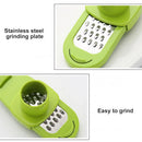 A close-up view shows the Lovely Home Icon 1PCS Garlic Crusher Press—a green, multi-functional manual tool for grinding garlic and ginger—featuring a durable stainless steel grinding plate. Text reads “Stainless steel grinding plate” and “Easy to grind.”.