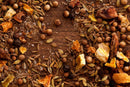 A close-up of assorted whole spices—including coriander seeds, fennel seeds, citrus peel, and salt—from the World Spice Americana Tasting Flight by World Spice, scattered on a rustic wooden surface—perfect for exploring a spice tasting journey inspired by regional USA flavors.