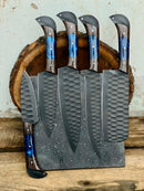 A Texan Knives 13" Forged Damascus Steel Chef Knife with a wenge wood resin handle and leather sheath is displayed on a wooden surface—a premium piece from the Knife Set for Sale, ideal as an impressive chef gift for any kitchen.