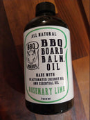 A bottle of BBQ Board Balm® Care Pair Wax and Oil by BBQ Boards®, a wood conditioner with rosemary lime scent, sits on a wooden surface. The mostly white label features green and black text.
