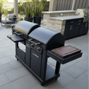 A modern patio features a BBQ Boards® Blackstone Pellet Grill Combo with front or side cutting board, control knobs, side shelves, and stone prep station with storage cabinets, all surrounded by stylish seating.