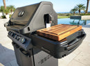 The BBQ Boards® Napoleon Prestige 500 Side Cutting Board by BBQ Boards® adds ample prep space to your outdoor gas grill, making patio BBQs by the pool and palm trees with ocean views even more convenient.