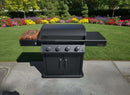 A BBQ Boards® Napoleon Rogue PRO Griddle Side Cutting Board by BBQ Boards® is attached to a black outdoor gas grill with four control knobs and a side shelf, set on a patio overlooking a lush lawn and vibrant flower garden.