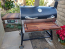 The BBQ Boards® Recteq RT-700 Pair, Front & Side Cutting Boards by BBQ Boards® offer prep space on your smoker grill. Designed for outdoor setups, these boards are perfect for patio grilling and provide durable surfaces right beside your cooking station.