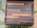 The BBQ Boards® Traeger Ironwood Side Cutting Board features a block-patterned design in rich brown shades, an edge groove, and an engraved BBQ logo, providing the ideal prep space for grilling on any outdoor surface.