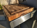 The BBQ Boards® Weber Spirit Old Gen Side Cutting Board features a thick wooden design with a juice groove and engraved BBQ logo, perfect as a grill side board for your outdoor prep station. Sunlight highlights its premium wood grain.