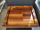 The BBQ Boards® Yoder YS480 or YS640 Side Cutting Board is a large wooden board with a juice groove, metal handles, and the BBQ Boards® logo—ideal as a side board on your grill countertop.