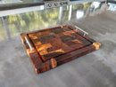 The BBQ Boards® Beefy BBQ Board® 18" x 15" cutting board features a rich, multi-toned wood grain and sturdy metal handles, making it perfect as a serving tray or brisket carving board in any modern kitchen.