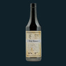 A dark glass bottle of Bourbon Barrel Foods Bluegrass Soy Sauce, featuring a beige and white label with product details and decorative text, set against a dark background and emphasizing its signature umami flavor.