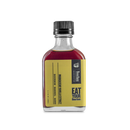 A small glass bottle with a black cap holds Bourbon Barrel Foods Bourbon Barrel Aged Madagascar Vanilla Extract, featuring a yellow label and aged in Kentucky bourbon casks.