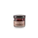 A small glass jar of Bourbon Barrel Foods Bourbon Barrel Aged Maple Syrup, aged in bourbon barrels for rich flavor. The jar has a black lid and a tan label with white and black text: "Maple Syrup Bourbon Barrel Aged.