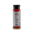A glass jar with a black lid holds a red spice. The back label lists nutrition, organic ingredients, and the Non-GMO Project Verified logo. Bourbon Barrel Foods is noted, recalling their Bourbon Barrel Aged Maple Syrup. White background.