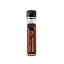 A clear glass bottle with a black cap contains Bourbon Barrel Foods Bourbon Barrel Aged Worcestershire Sauce. The brown label highlights its rich umami flavor and features the Bourbon Barrel Foods branding.