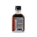 A small glass bottle with a black cap contains Bourbon Barrel Foods Bourbon Barrel Aged Worcestershire Sauce. The dark, umami-rich liquid's label displays nutrition facts, ingredients, and a barcode against a plain white background.