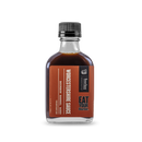 A clear glass bottle with a black cap holds Bourbon Barrel Foods Bourbon Barrel Aged Worcestershire Sauce. The brown label says "EAT YOUR Bourbon" and features white and black text highlighting its rich umami flavor.