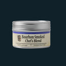 A 3.5 oz silver tin of Bourbon Barrel Foods Bourbon Smoked Chef's Blend all-purpose smoky seasoning is shown against a plain dark background.