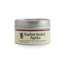 A 2.5 oz (71 g) small silver tin of Bourbon Barrel Foods Bourbon Smoked Paprika features a cream label reading "Handcrafted.