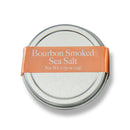 Bourbon Barrel Foods Bourbon Smoked Sea Salt comes in a 0.75 oz round metal tin with an orange label—a rich, smoky finishing salt that elevates your favorite dishes with bold flavor.