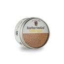 A round metal tin labeled "Bourbon Barrel Foods Bourbon Smoked Vanilla Sugar" sits on a plain white background, filled with light brown sugar crafted by Bourbon Barrel Foods using Madagascar vanilla.