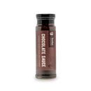 A glass jar of Bourbon Barrel Foods Chocolate Sauce—Bourbon Smoked Cacao Nibs & Bourbon—with a black lid and brown label featuring large white lettering, a cocoa bean illustration, bourbon highlights, and a small brand logo at the top.