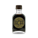 A clear glass bottle with a brown cap contains Bourbon Barrel Foods Imperial Double Fermented Bluegrass Soy Sauce, featuring gold lettering on a black label highlighting its double fermented and bourbon barrel aged qualities.