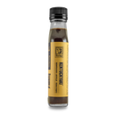 A clear glass bottle with a black cap holds dark liquid and features a yellow label reading "Bourbon Barrel Foods Kentuckyaki™." It stands upright against a plain white background—a true Kentucky-style teriyaki sauce.