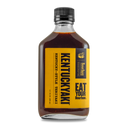 A bottle of Bourbon Barrel Foods Kentuckyaki™ with a yellow "Eat Your Bourbon" label sits on a white background, ideal as an all-natural marinade or bourbon teriyaki sauce for your favorite dishes.