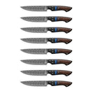 The Folded Steel Dahlia 8-Piece Steak Knife Set features AUS10 stainless Damascus steel blades with intricate patterns and dark wooden handles accented in blue, arranged vertically on a white background.