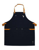 The Folded Steel Chef Apron with Eco-Friendly rPET Canvas features a dark blue design, brown adjustable straps, three front pockets, and a small white embroidered rose—a stylish, sustainable choice for any kitchen.