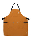 The Folded Steel Chef Apron with Eco-Friendly rPET Canvas Construction features black adjustable straps, three front pockets, and subtle embroidery. This sustainable brown apron is laid flat on a white background.