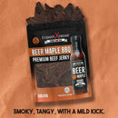 A package of Elijah's Xtreme BBQ Bro Box Ultimate Gift Set is shown against a brown background, with jerky pieces peeking out. Text reads: Smoky, tangy, with a mild kick—the perfect BBQ gift set for flavor lovers. Brand: Elijah's Xtreme.