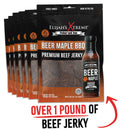 Six packs of Elijah’s Xtreme Beer Maple BBQ Beef Jerky by Elijah's Xtreme are displayed, featuring a bottle of Beer Maple marinade on the front. Below, text reads "Over 1 pound of high-protein snack," highlighted with a red upward arrow.